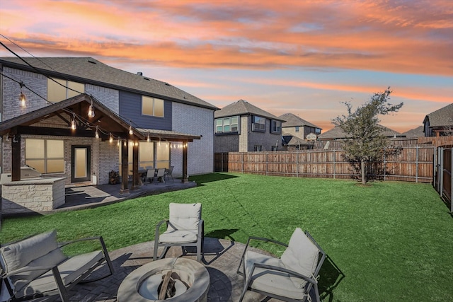 yard at dusk with a fire pit and a patio area