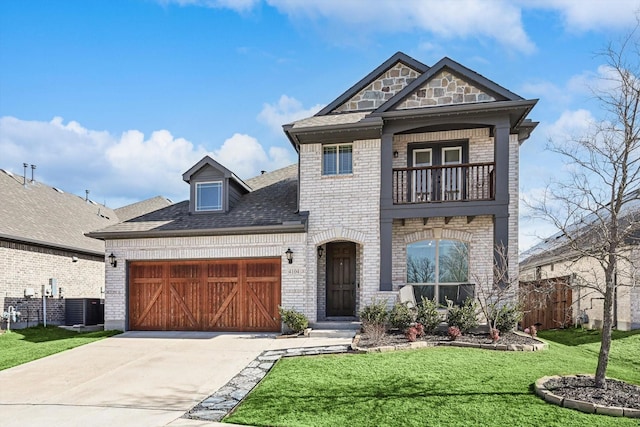 view of front of home featuring cooling unit, a balcony, a front lawn, and a garage