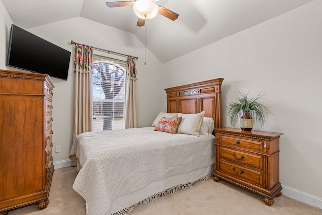 bedroom featuring ceiling fan, light colored carpet, and vaulted ceiling