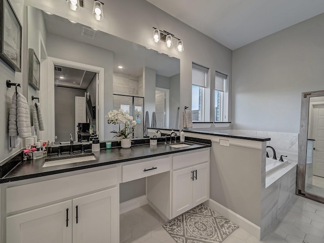 bathroom featuring vanity, tile patterned flooring, and separate shower and tub