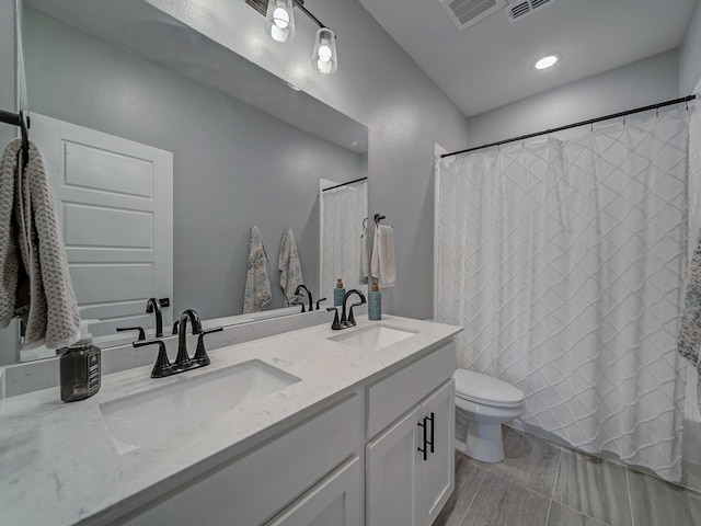 bathroom featuring toilet and vanity