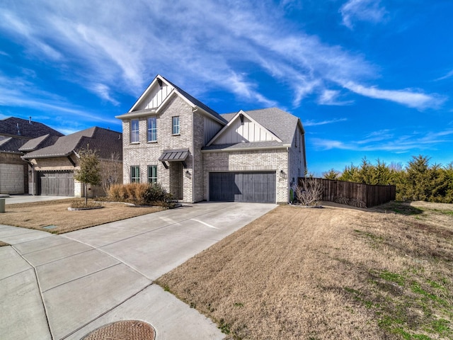 view of front of property featuring a garage and a front lawn