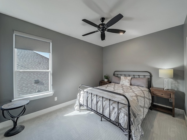 carpeted bedroom with ceiling fan and multiple windows