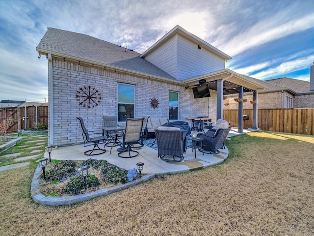 rear view of house with a yard and a patio