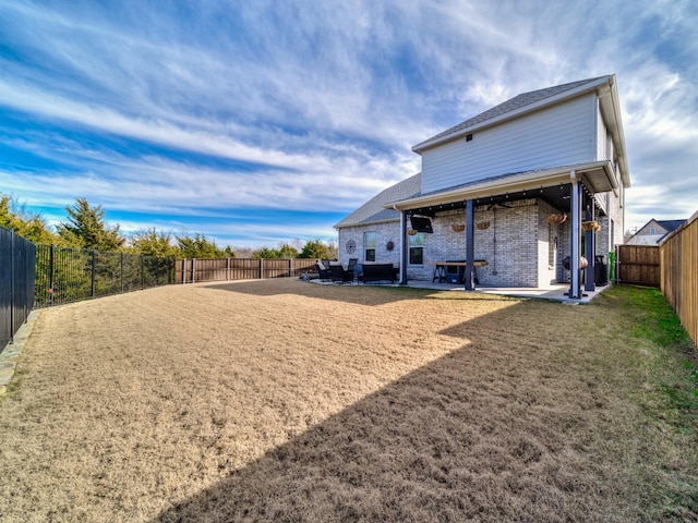 back of property featuring a patio and a lawn