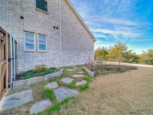 view of side of home featuring a yard