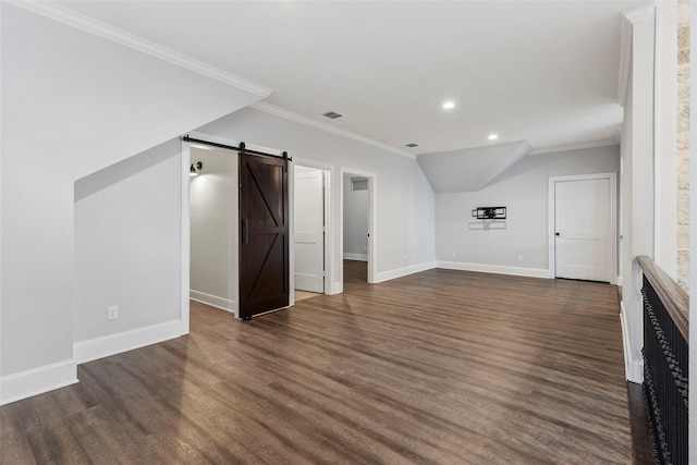 bonus room with a barn door and dark wood-type flooring