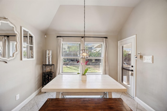 unfurnished dining area featuring an inviting chandelier, lofted ceiling, and light tile patterned floors