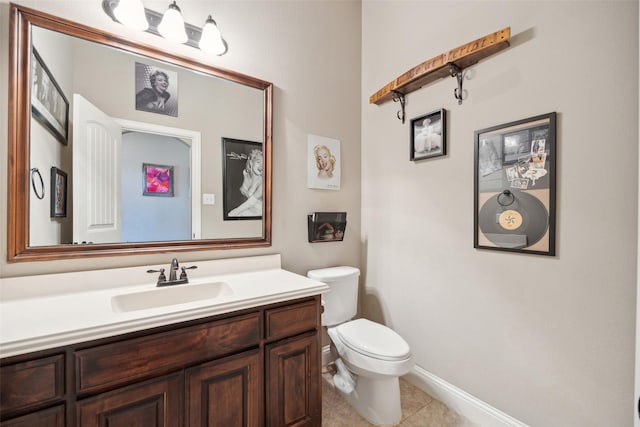 bathroom featuring toilet, vanity, and tile patterned flooring