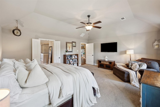 bedroom featuring lofted ceiling, ceiling fan, light carpet, and connected bathroom