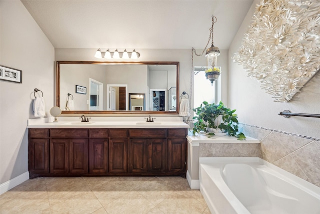 bathroom with a bathing tub, vaulted ceiling, tile patterned floors, and vanity