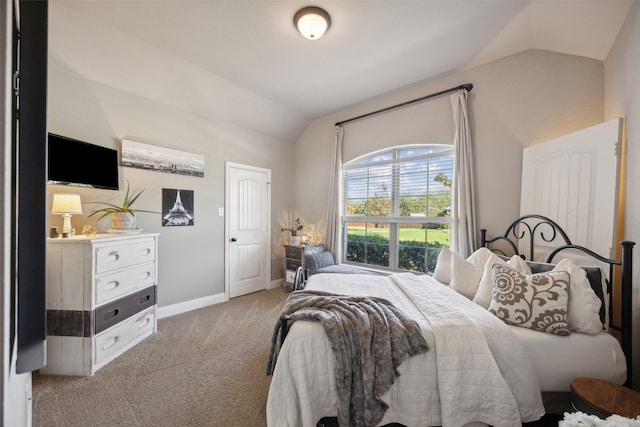 bedroom featuring light colored carpet and vaulted ceiling