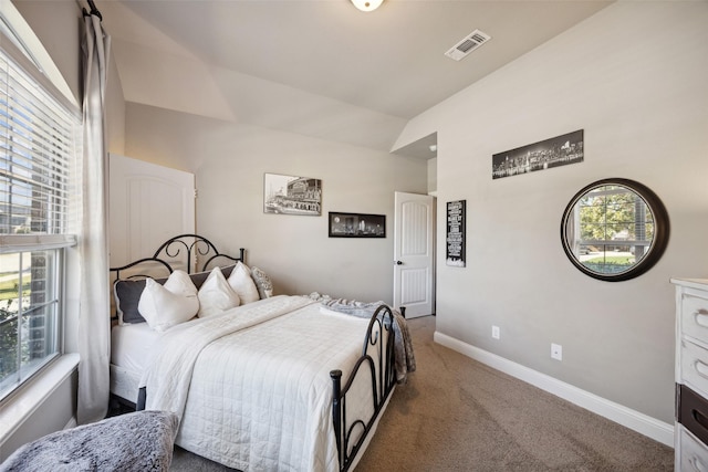 carpeted bedroom featuring vaulted ceiling