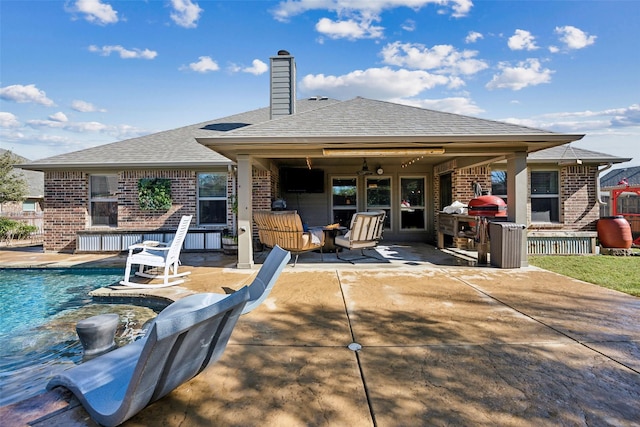 back of house with ceiling fan and a patio area