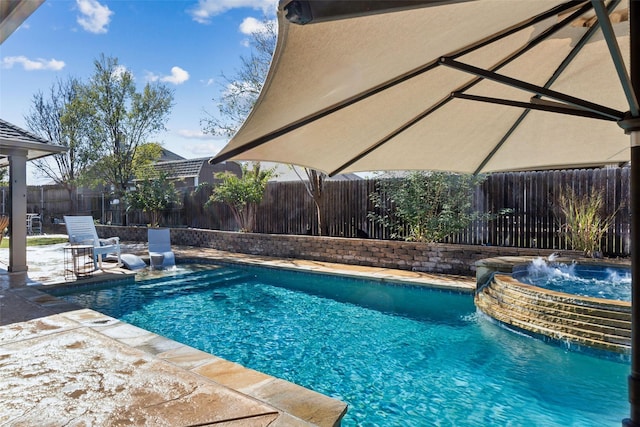 view of pool with pool water feature, an in ground hot tub, and a patio