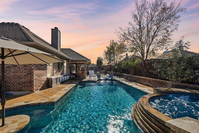 view of pool at dusk