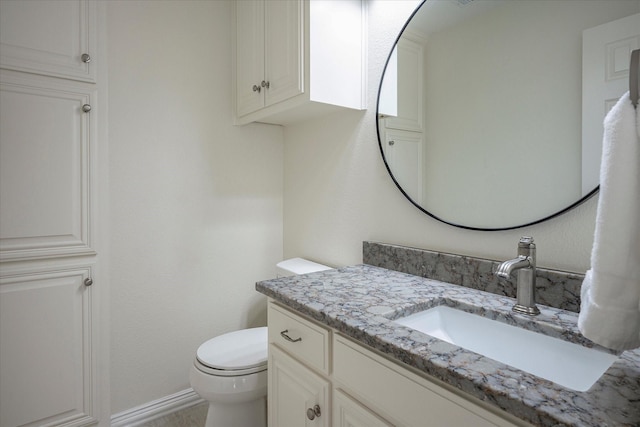 bathroom with toilet and vanity