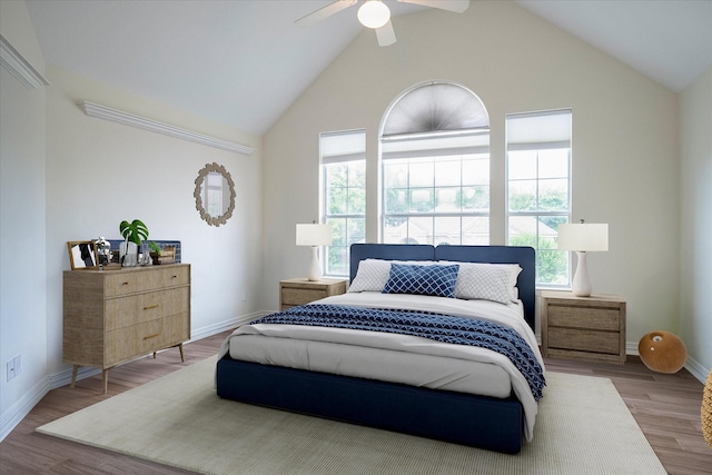 bedroom featuring ceiling fan, vaulted ceiling, and light wood-type flooring