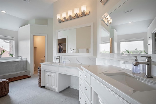 bathroom featuring tile patterned flooring, vaulted ceiling, vanity, and toilet