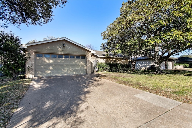 single story home with a front yard and a garage