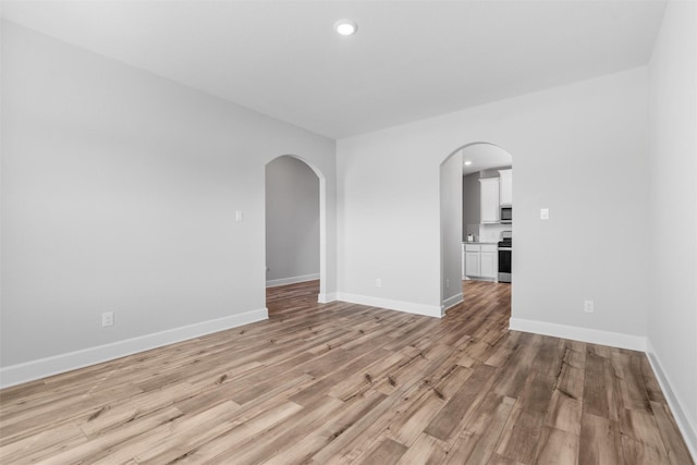 unfurnished room with light wood-type flooring