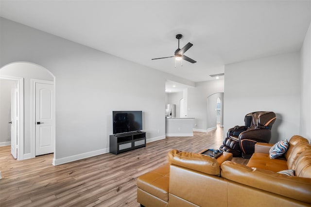 living room featuring ceiling fan and light wood-type flooring