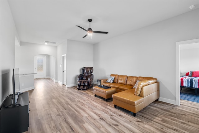 living room with ceiling fan and light hardwood / wood-style flooring