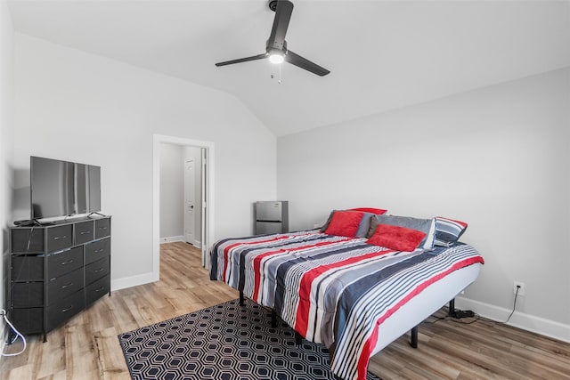 bedroom featuring hardwood / wood-style flooring, ceiling fan, and vaulted ceiling