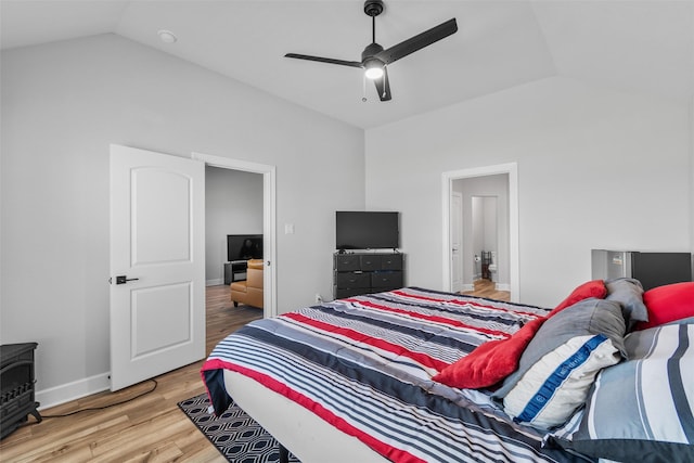 bedroom with ceiling fan, vaulted ceiling, and wood-type flooring