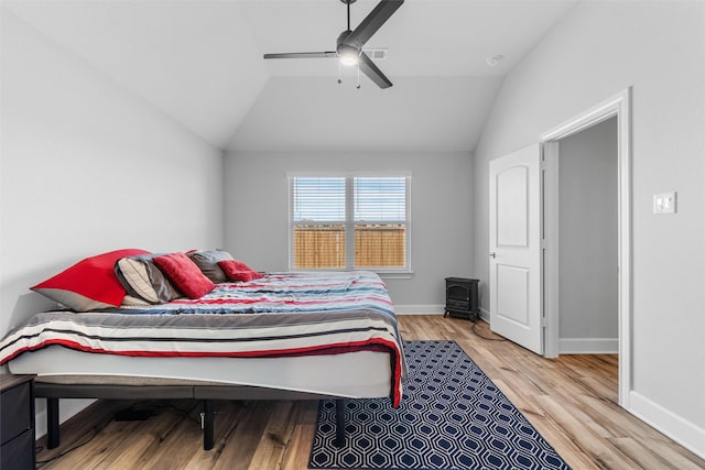 bedroom with ceiling fan, hardwood / wood-style floors, and lofted ceiling