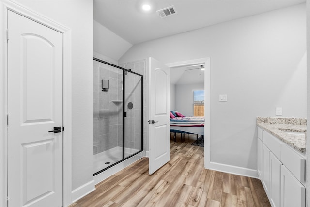 bathroom with lofted ceiling, an enclosed shower, ceiling fan, wood-type flooring, and vanity