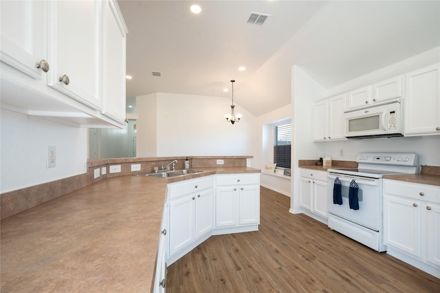 kitchen with sink, white appliances, white cabinetry, and pendant lighting