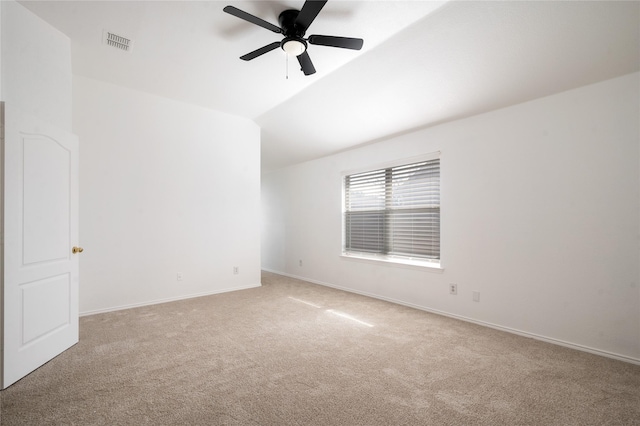 carpeted spare room with lofted ceiling and ceiling fan