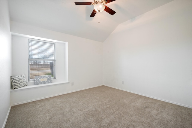 carpeted empty room with ceiling fan and vaulted ceiling