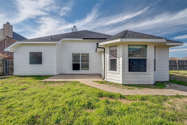 rear view of property with a patio area and a lawn