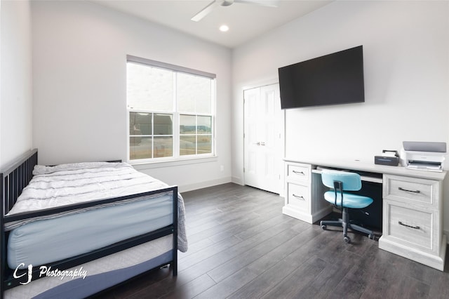 bedroom with dark hardwood / wood-style flooring, ceiling fan, and a closet