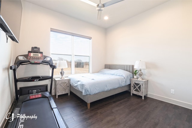 bedroom with dark hardwood / wood-style flooring and ceiling fan