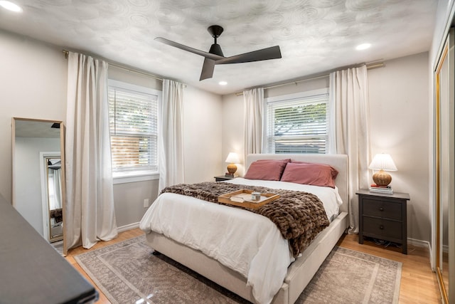 bedroom with ceiling fan and light hardwood / wood-style floors