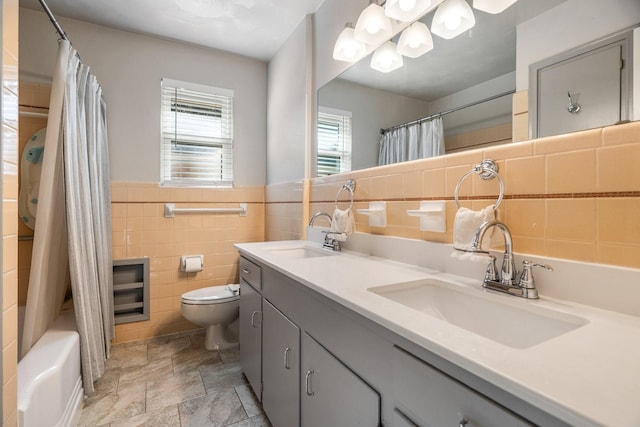 full bathroom featuring toilet, tile walls, shower / bath combo, and vanity