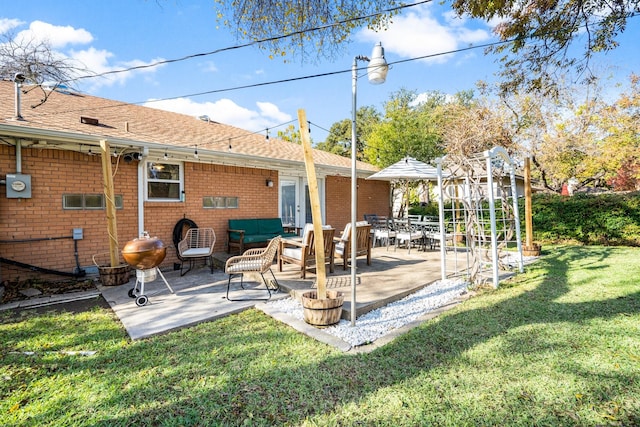 back of property featuring a patio area and a yard