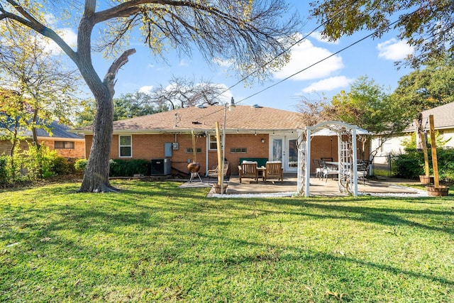 back of house featuring a lawn and a patio area