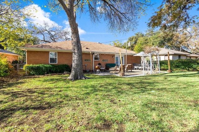 back of house featuring a patio area and a lawn