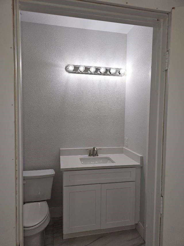 bathroom featuring toilet and vanity