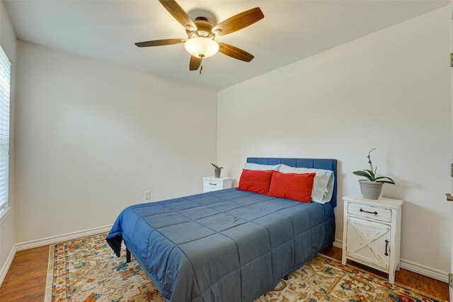 bedroom with wood-type flooring and ceiling fan