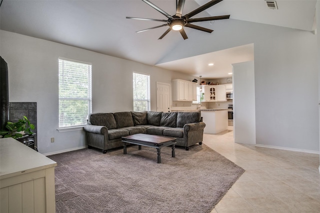 tiled living room featuring lofted ceiling and ceiling fan