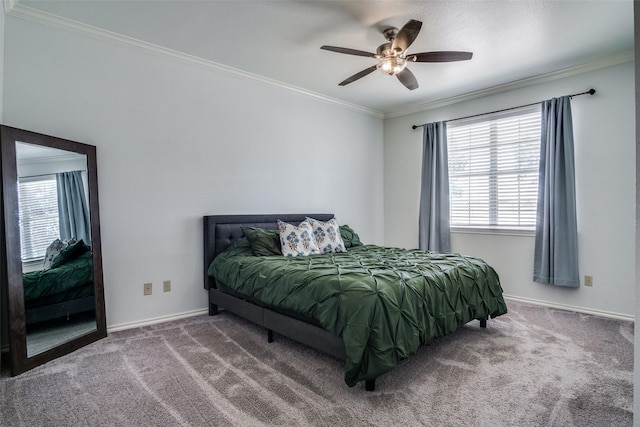 carpeted bedroom featuring ceiling fan and crown molding