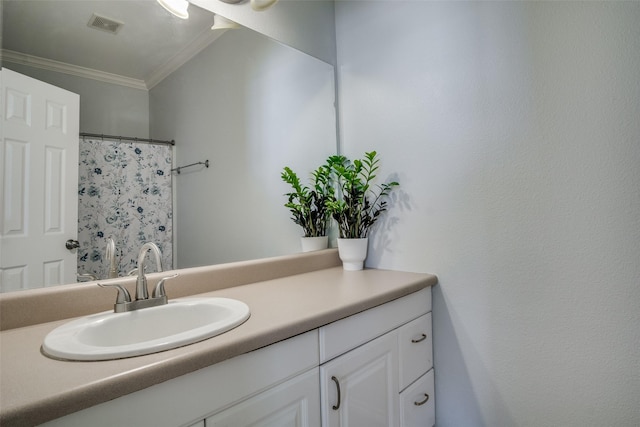 bathroom featuring ornamental molding and vanity