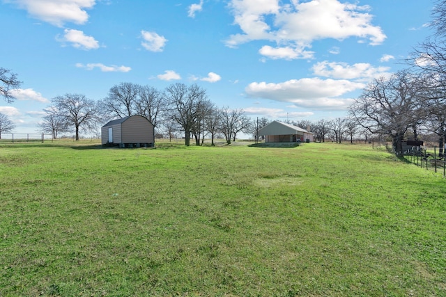 view of yard featuring a rural view and a shed