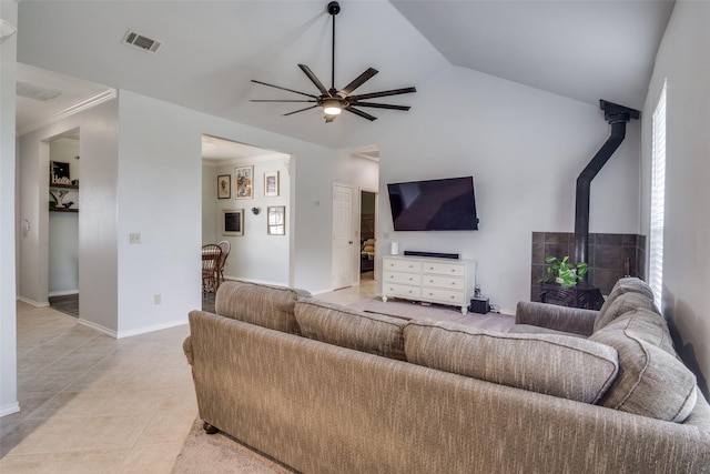 tiled living room featuring lofted ceiling, ceiling fan, and ornamental molding