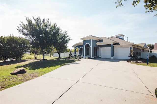 view of front of home featuring a front lawn and a garage